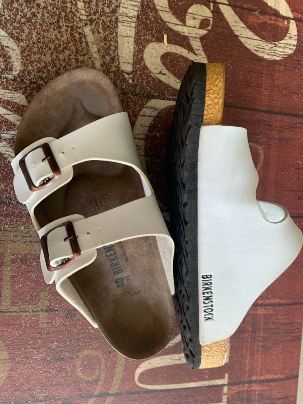 Birkenstock White Arizona Two-Strap Sandals with Brown Buckles